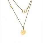 14 Karat Gold Taurus Zodiac Charm On Light Brown Silk