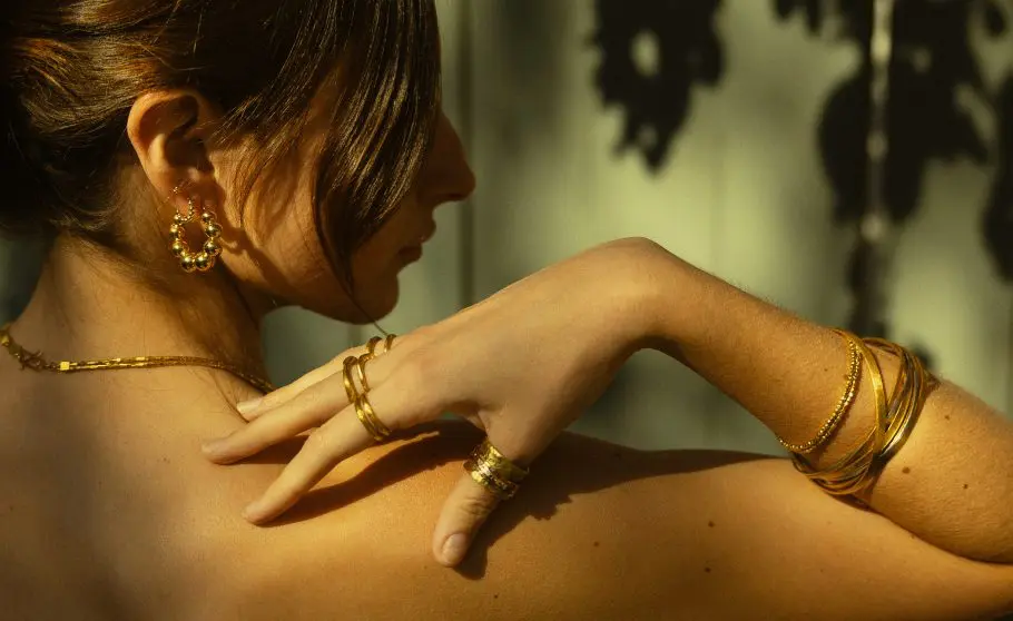 Woman showing off gold jewlery