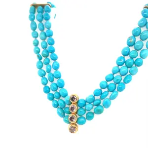Turquoise beaded necklace featuring a gold clasp and three decorative stones at the center, showcasing a vibrant and elegant design suitable for various occasions.