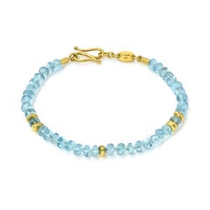 Delicate blue gemstone bracelet featuring sparkling aquamarine beads and gold accents, perfect for adding a touch of elegance to any outfit.